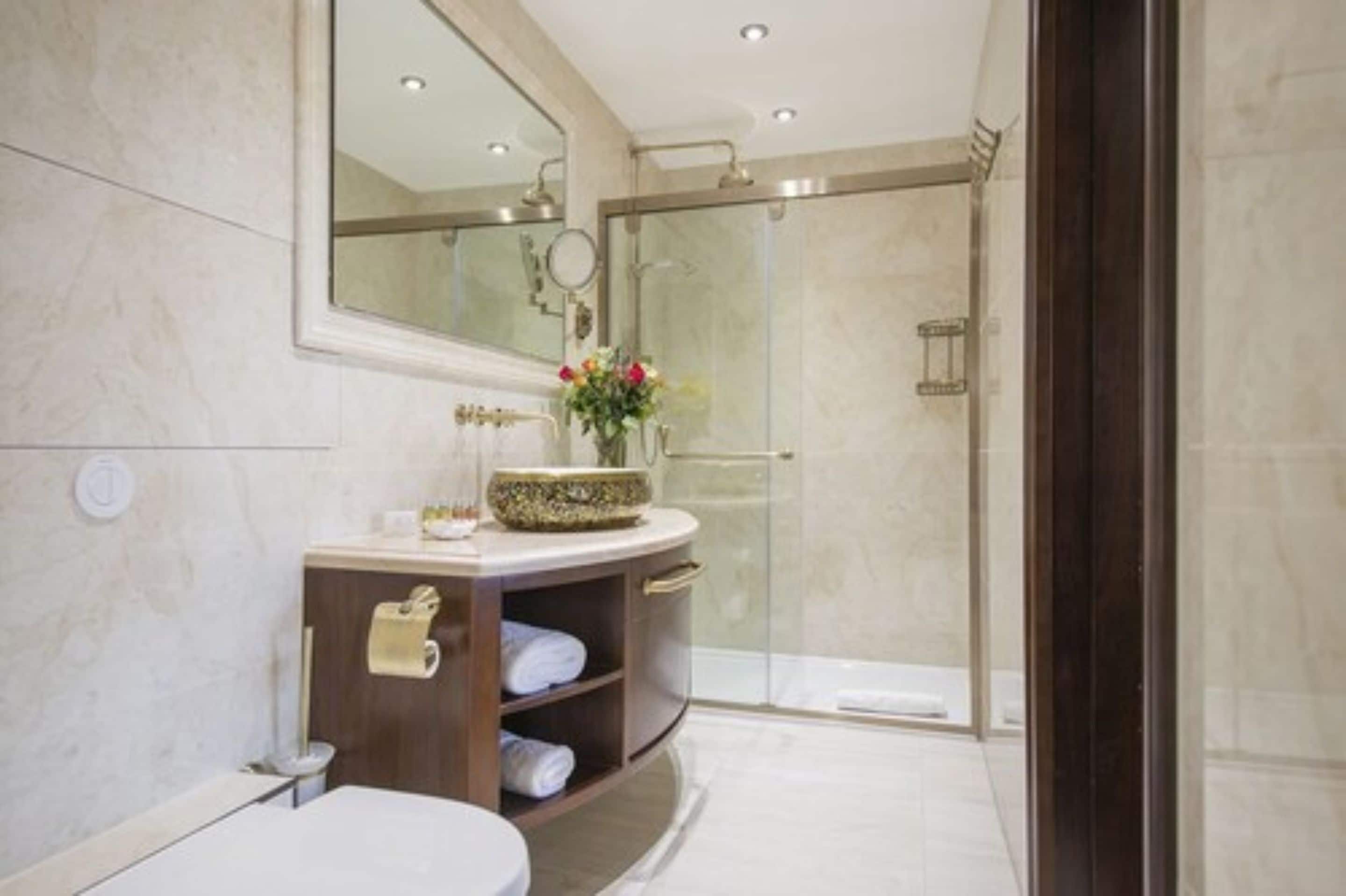 separate bathtub and shower, rainfall showerhead, designer toiletries