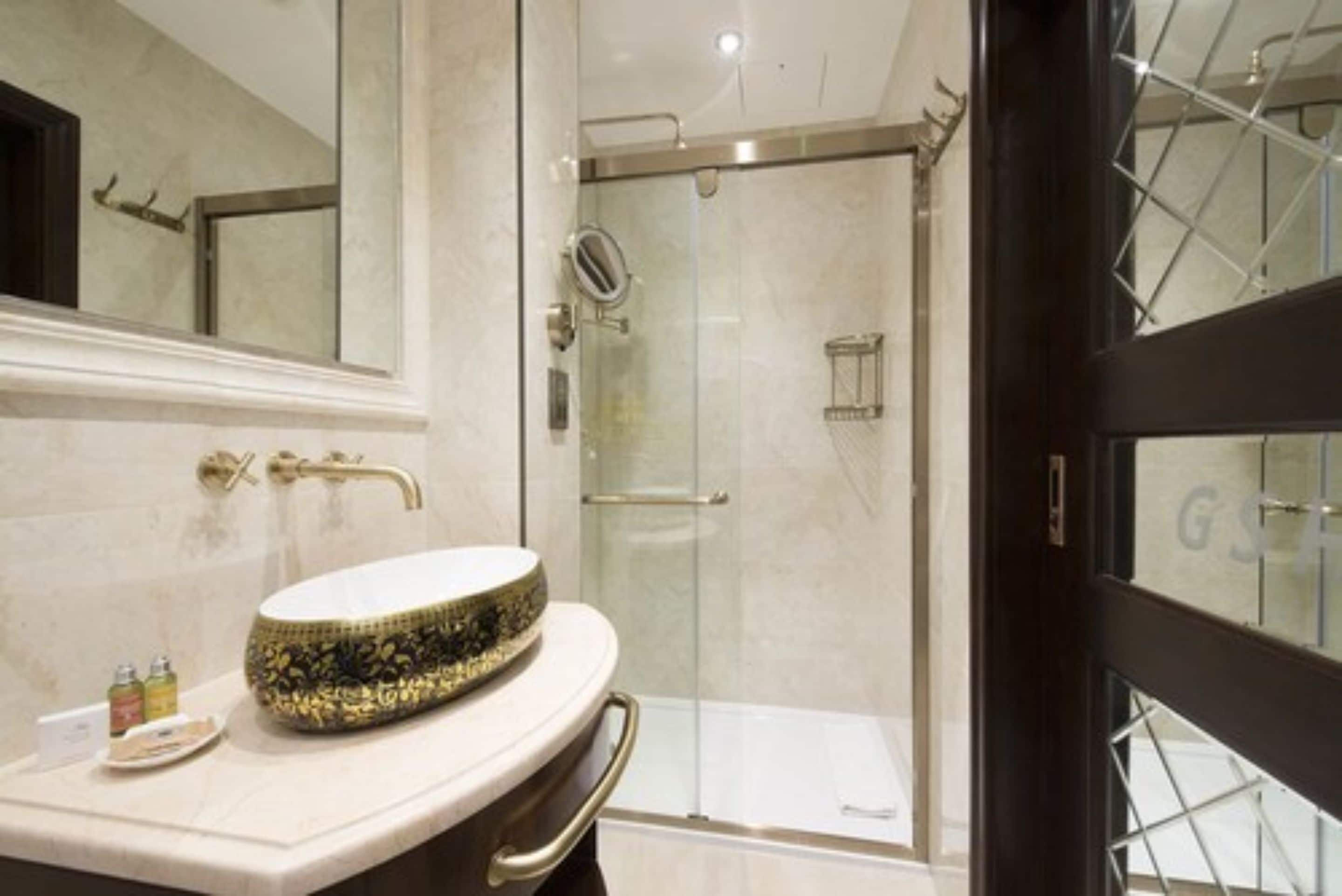 separate bathtub and shower, rainfall showerhead, designer toiletries