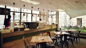 A restaurant with a counter, tables, and chairs. - 106 on Adderley Accommodation (Cape Town)