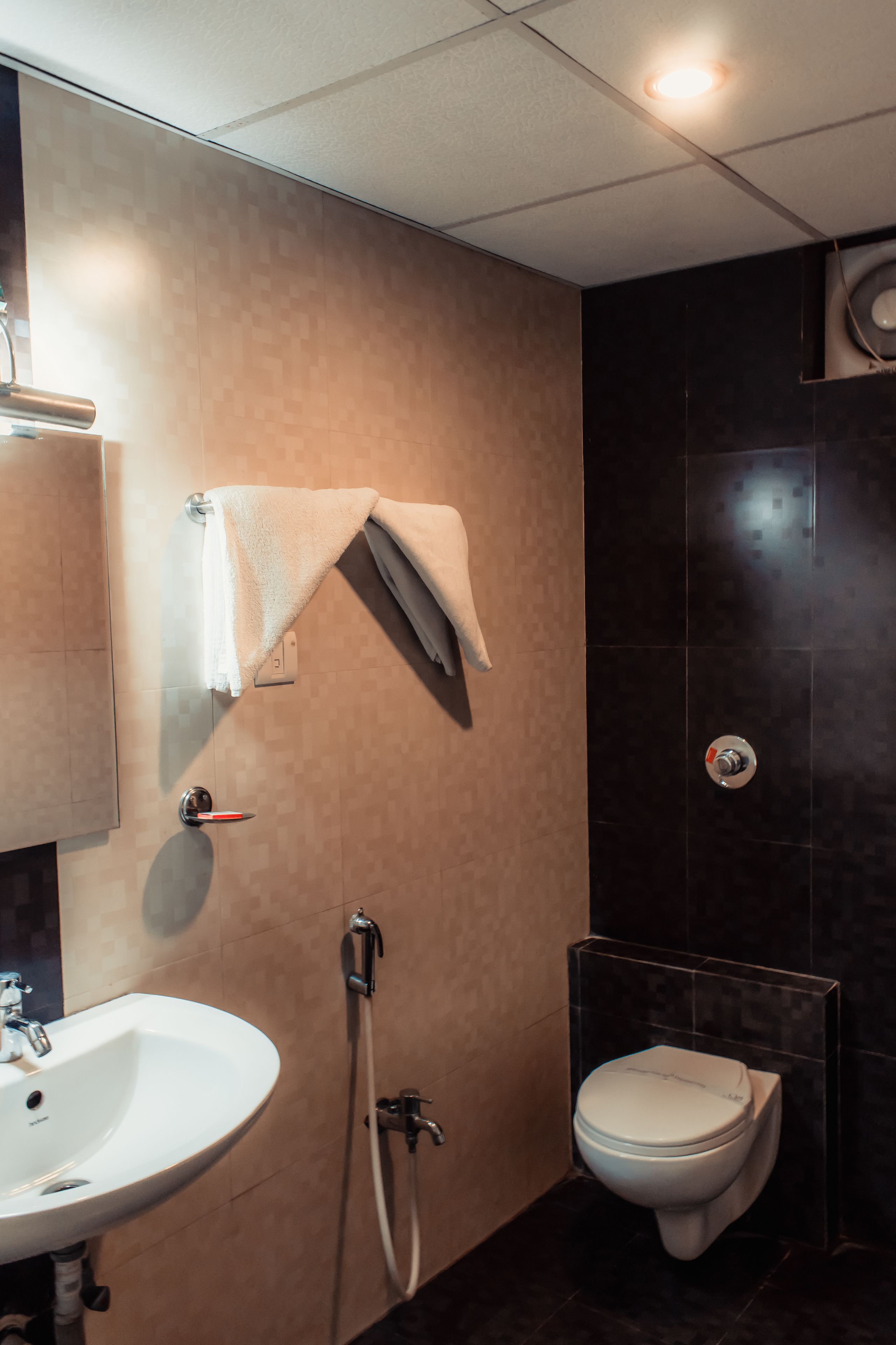 A bathroom with a sink, toilet, and shower.