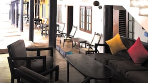 A modern interior with a staircase, seating area, and a view of the outside. - Turtles Rest and Curry Bowl (Hikkaduwa)