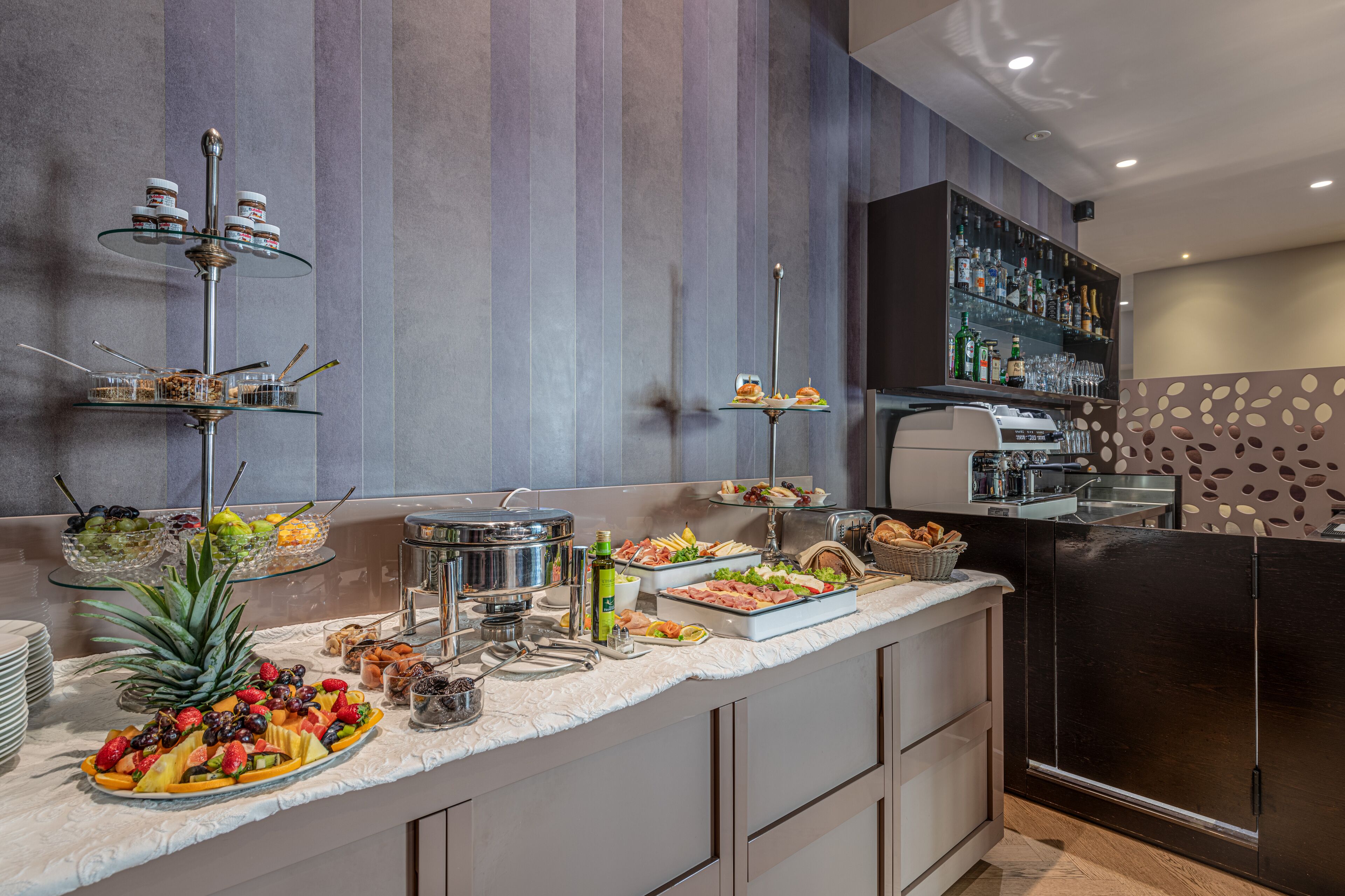 A buffet setup with various food items and condiments.