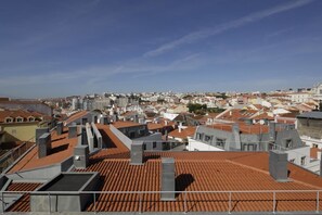 A cityscape with a variety of building styles and rooftops, including flat and sloped designs. - Santa Catarina Superior Apartments by linc (Lisbon)