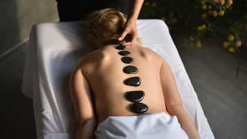 Experience a soothing massage on a comfortable massage table, surrounded by a peaceful atmosphere.