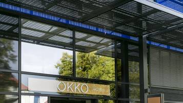 A modern hotel entrance with a sign reading "OKKO HOTELS".