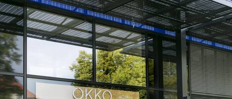 A modern hotel entrance with a sign reading "OKKO HOTELS".