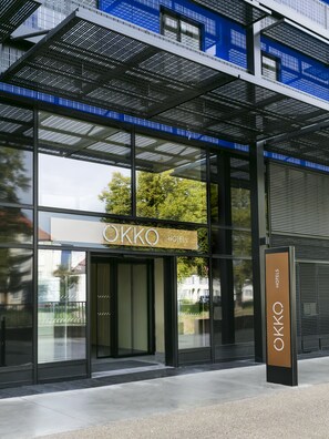 A modern hotel entrance with a sign reading "OKKO HOTELS". - OKKO Hotels Strasbourg Centre (Strasbourg)