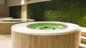 A spa area with wooden flooring and a green wall.