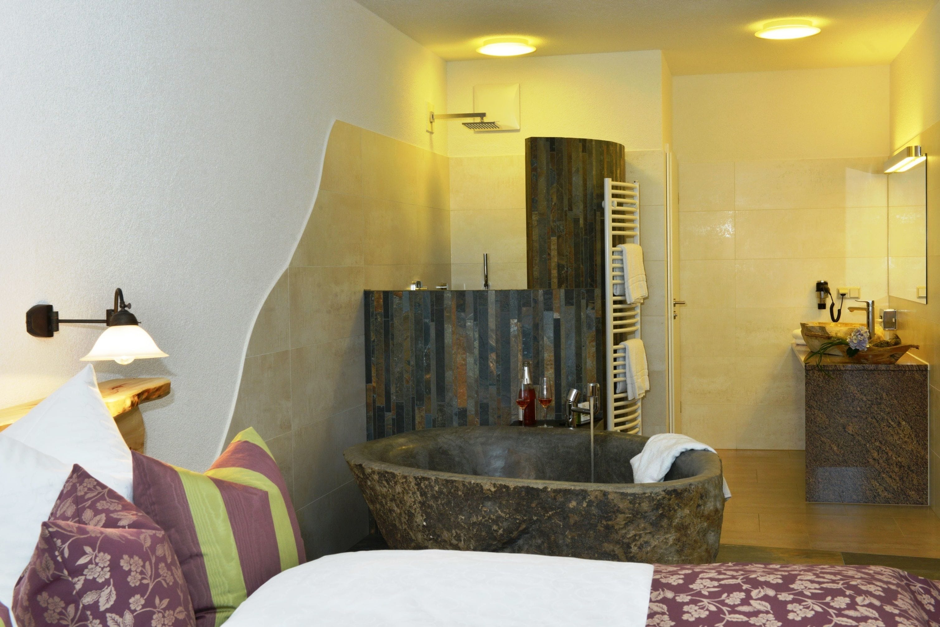 A modern bathroom with a freestanding bathtub, a shower, and a vanity with a mirror.