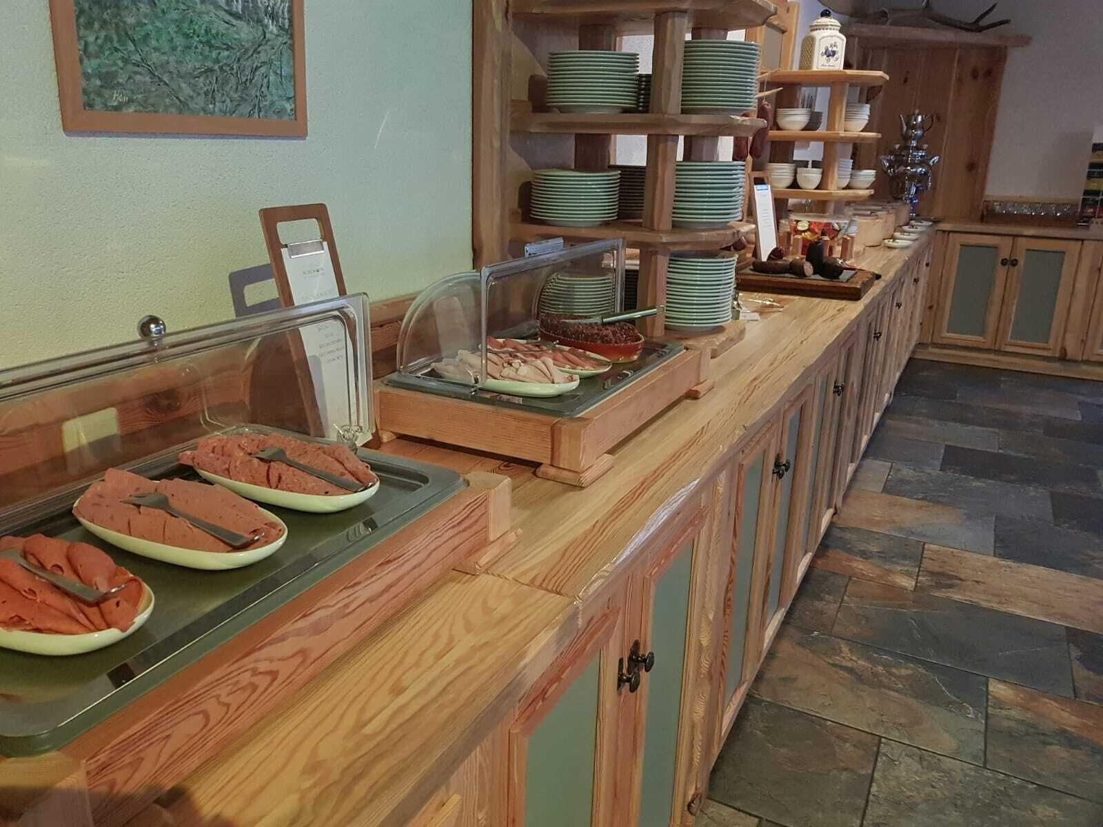 A buffet setup with various food items and a glass display case.