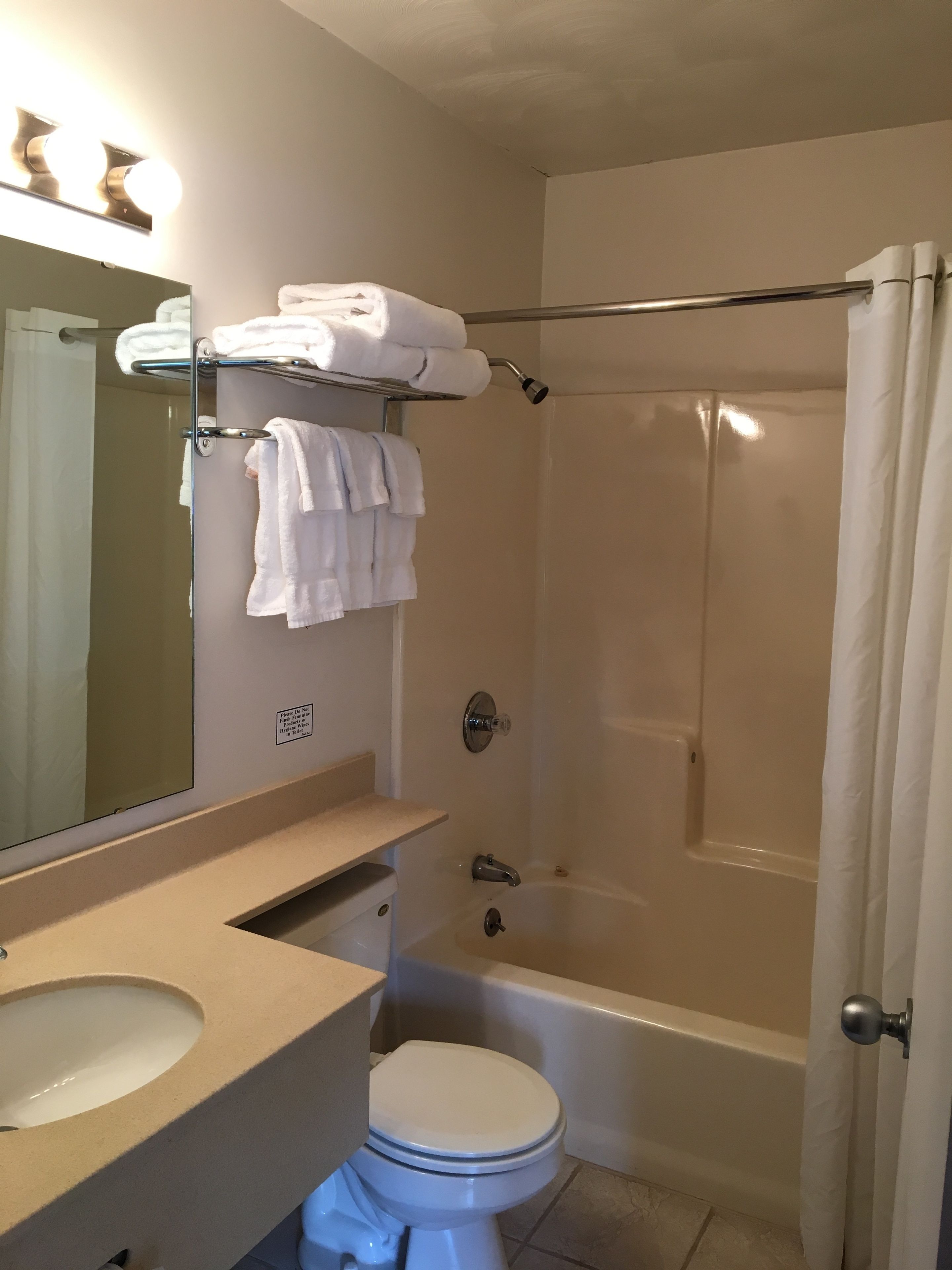 A bathroom with a toilet, sink, and bathtub.