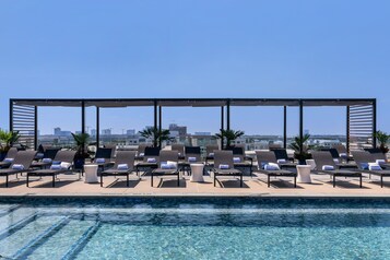 Outdoor pool, open 11:00 AM to 7:00 PM, pool loungers