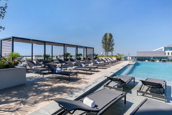 Outdoor pool, open 11:00 AM to 7:00 PM, pool loungers