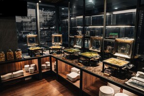 A buffet setup with various food stations, including a sign for 'Garlic Fried Rice'. - All Nite & Day Palembang - Veteran (Palembang)