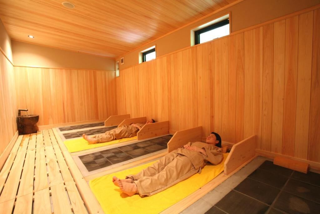A sauna room with wooden walls and benches.