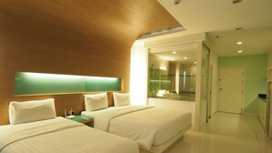 A hotel room with two beds, a large mirror, a shower area, and a door leading to another room. - Viewtalay6 by Pat 42 (Pattaya)
