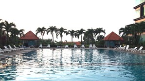 A swimming pool with lounge chairs and palm trees. - Viewtalay6 by Pat 42 (Pattaya)
