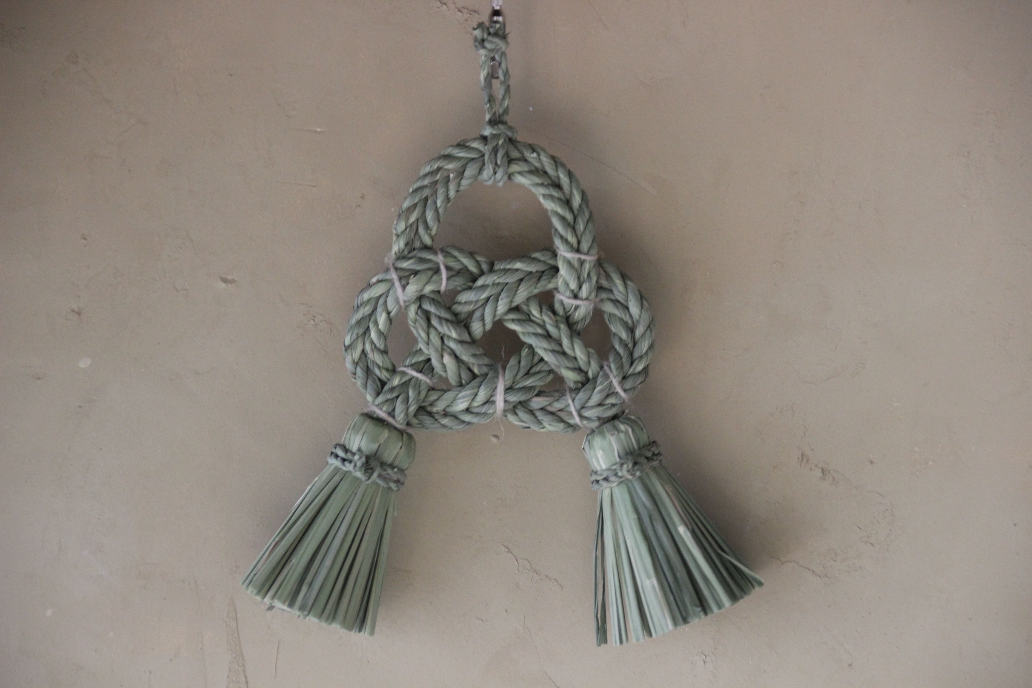 A rope wall hanging with tassels.