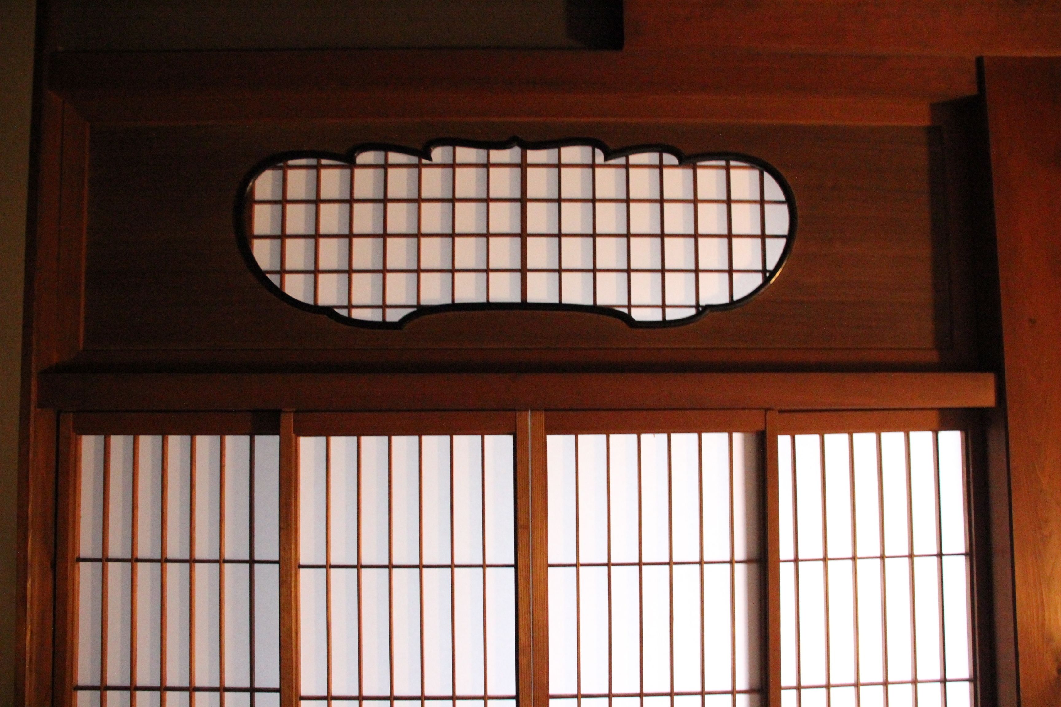 A traditional Japanese shoji screen with a grid pattern.