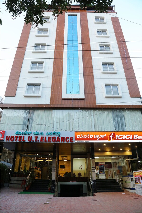 A multi-story hotel with a prominent vertical blue stripe.