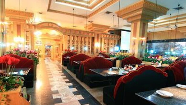 A hotel lobby with a long corridor, red upholstered seating, and a patterned floor. - 13 Coins Ngamwongwan Hotel (Nonthaburi)