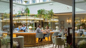 A bar area with a counter, seating, and plants. - Marcliffe (Aberdeen)