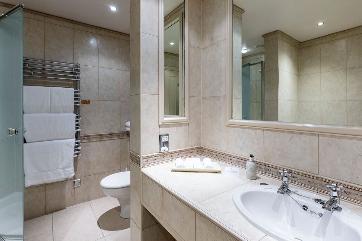 suite | bathroom | designer toiletries, hair dryer, bathrobes, slippers