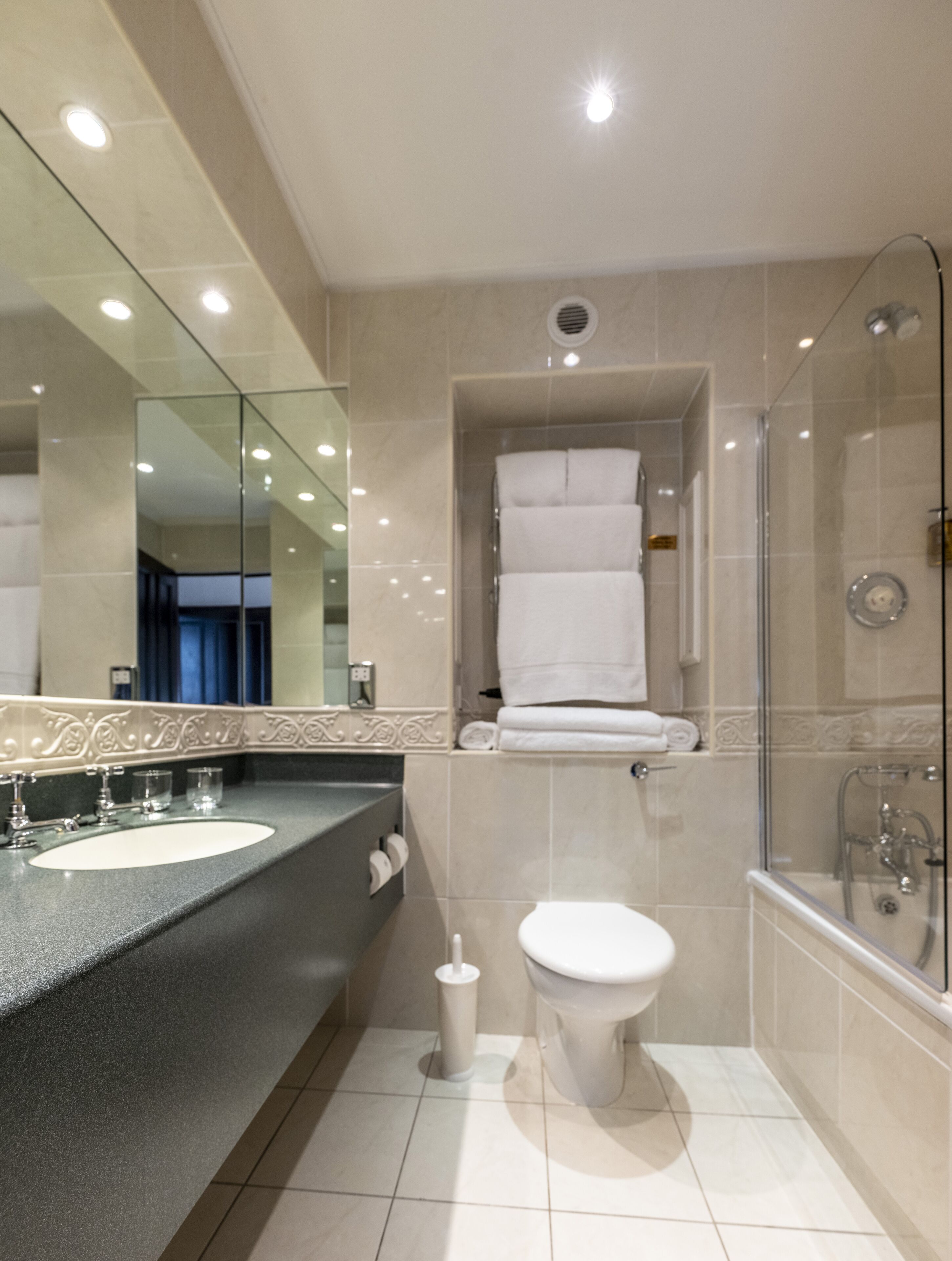 deluxe suite | bathroom | designer toiletries, hair dryer, bathrobes, slippers