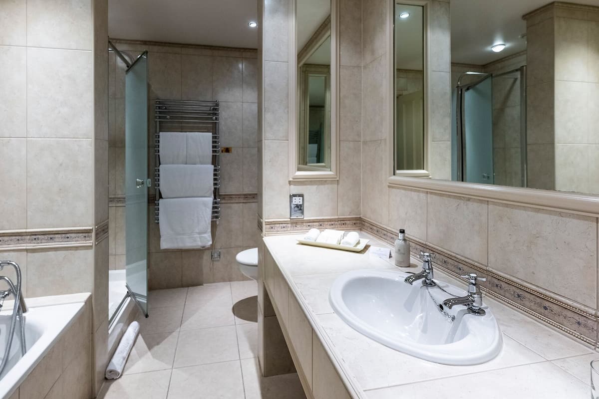 suite | bathroom | designer toiletries, hair dryer, bathrobes, slippers
