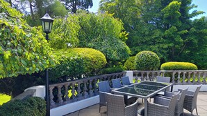 An outdoor patio with wicker furniture and a stone balustrade. - Marcliffe (Aberdeen)