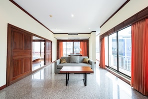 Suite, 1 King Bed | Living area | 32-inch flat-screen TV with cable channels, TV