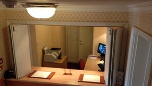 A hotel reception area with a desk, a computer monitor, and a telephone. - Ashley Hotel (Cambridge)
