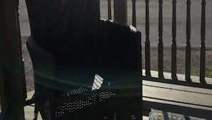 A view from a balcony overlooking a body of water with a distant landmass. - Inn By The Bay (Dildo)