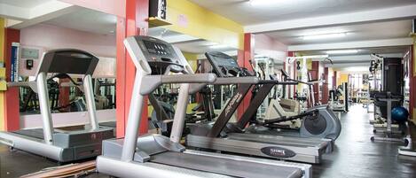 A gym with multiple treadmills and exercise equipment.