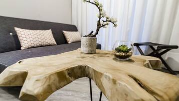 Une table en bois avec un vase de fleurs et un verre d’eau.