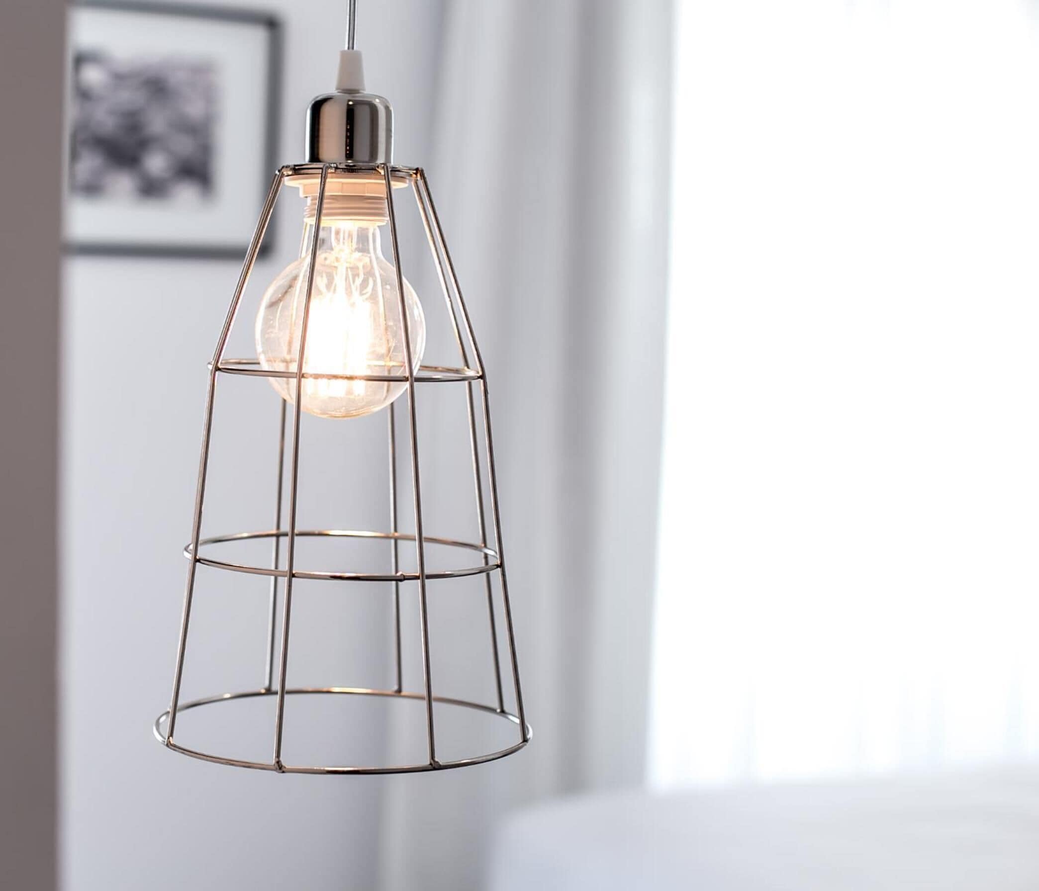 A pendant light with a clear glass shade and a metal frame.
