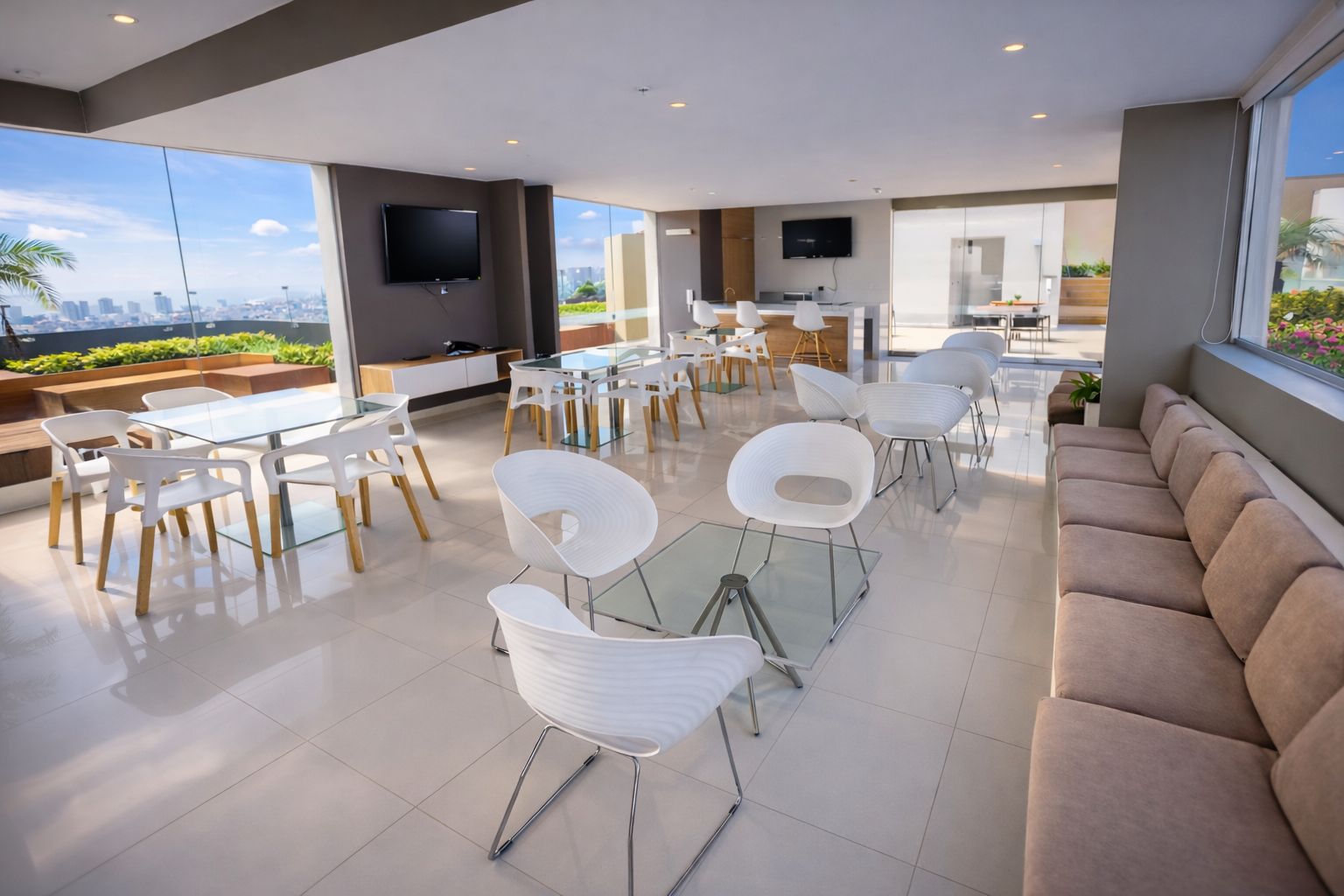 A modern interior with glass tables and chairs, a sofa, and a TV mounted on the wall.