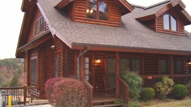 A log cabin with a porch, a front door, and a staircase leading to the entrance. - THE ONLY THING MISSING  YOU!Hot tub,air hockey,pool,no animals no smoking sleep6 (Pigeon Forge)