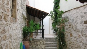 A narrow stone staircase leading to a wooden porch with a tiled roof. - Villa with private pool garden and BBQ at quiet Cretan village just outside city (Rethymnon)