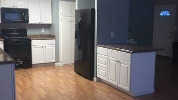 Enjoy cooking in this well-equipped kitchen with microwave and stove, featuring a large window with an outside view.