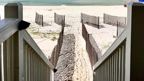 A beach pathway leading to the ocean with a clear sky. - Gulf front home on North Cape, outdoor kitchen, elevator @ lots of beach gear (Port St Joe)