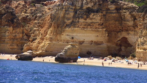 A coastal beach with rocky cliffs and a sandy shore. - Superb Albufeira apartment in the Algarve (la Marina Albufeira)