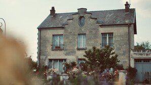 A two-story stone building with a symmetrical facade, multiple windows, and a central entrance. - Chez Ric et Fer (Coucy-le-Chateau-Auffrique)