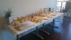 A breakfast buffet with various food items and condiments on a table. - Norrskedika hotell - Gamla Järnhandeln (Osthammar)