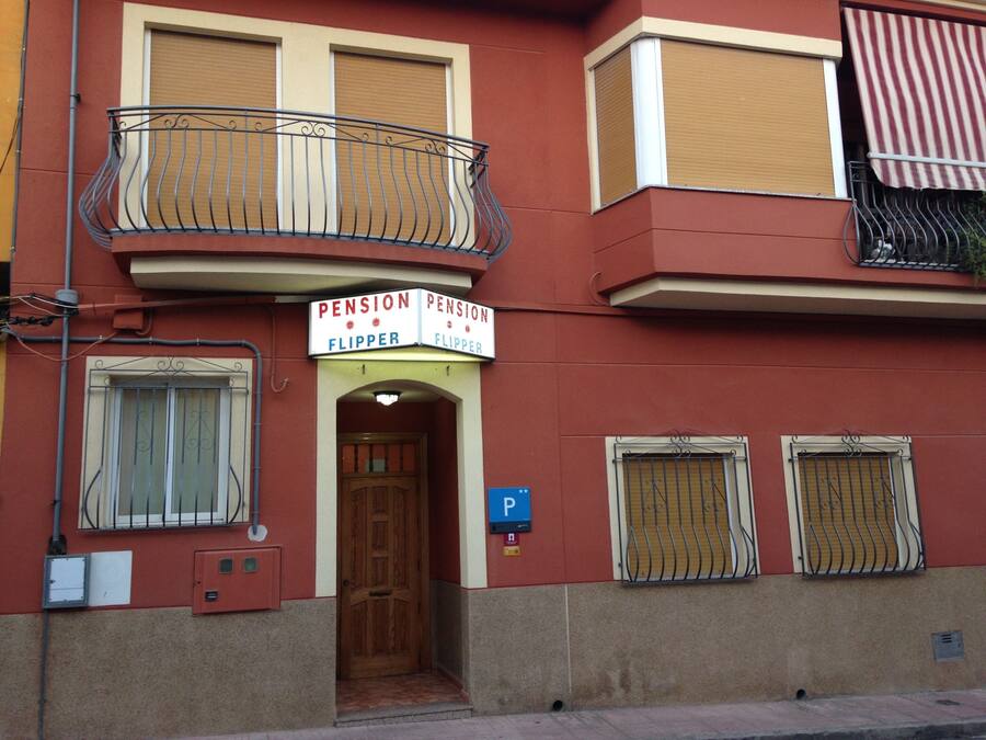 A building with a sign reading "Pension Flipper" above the entrance.