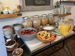 A breakfast buffet with various food items and containers. - Oaklands Guest House (Weymouth)