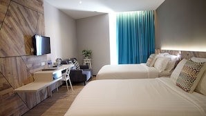 A modern hotel room with a large bed, a desk with a chair, a television, and a window with blue curtains. - G5 Hotel & Serviced Apartment (Johor Bahru)
