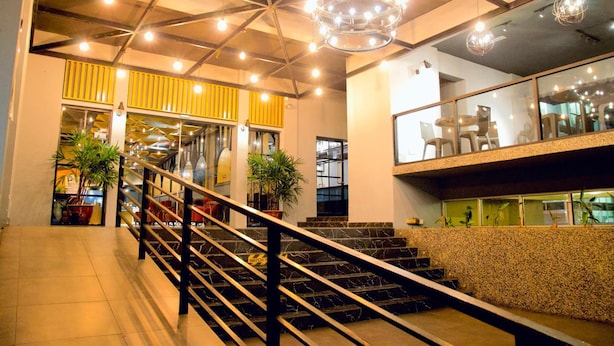 A modern interior with a staircase, a chandelier, and potted plants. - G5 Hotel & Serviced Apartment (Johor Bahru)
