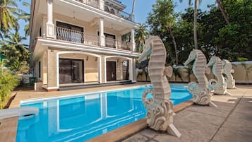 Outdoor pool, a waterfall pool, open 8:00 AM to 8:00 PM, pool loungers