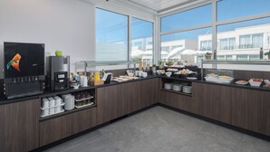 A modern kitchen with a coffee machine, breakfast items, and large windows. - Apartments Maj Residence Premium (Porec)
